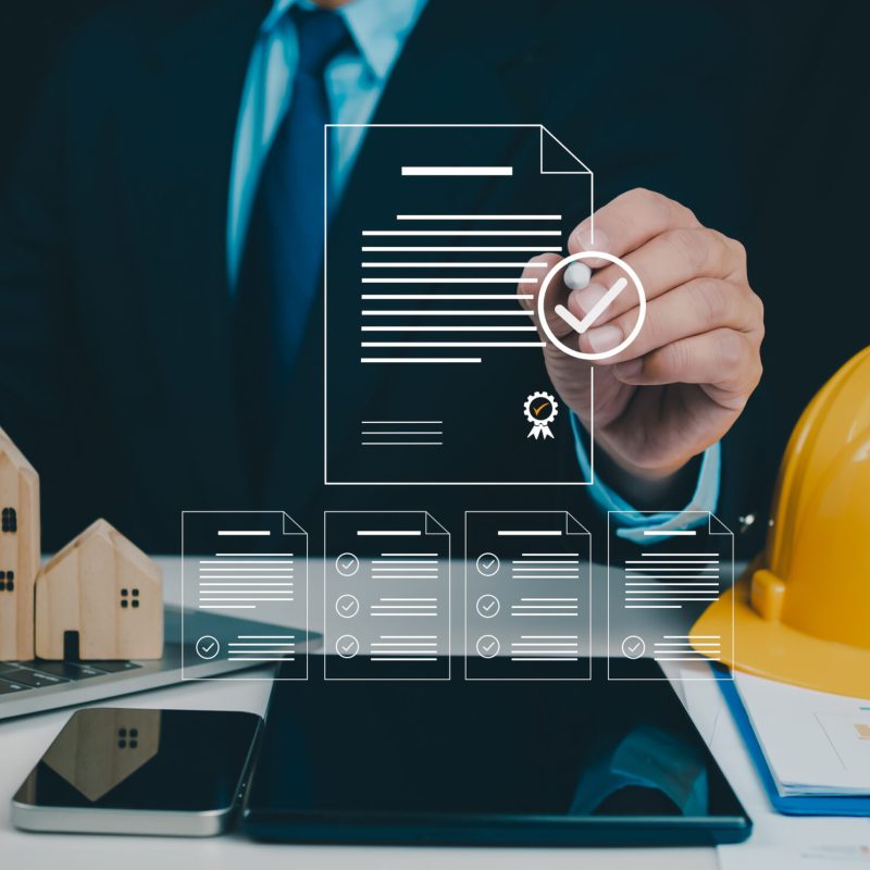Architect or engineer Checking the list of documents and approving the project, Approved Buildings Permit concept with approved residential building project, Construction project inspection.